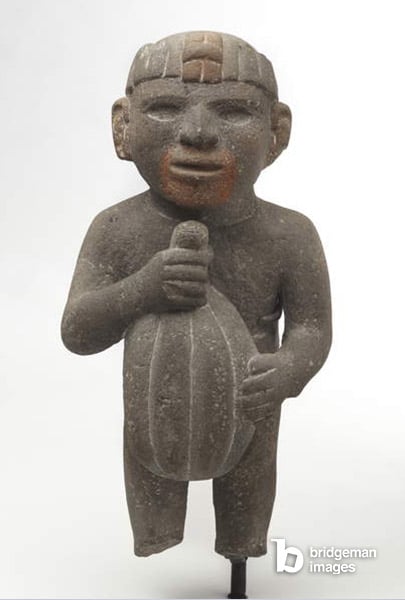 Man carrying a cacao pod, 1440-1521 (volcanic stone with traces of red pigment), Aztec  © Brooklyn Museum of Art  Museum Collection Fund / Bridgeman Images 