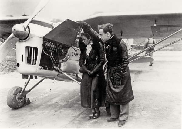 Amy Johnson (1903-41) and James Allan Mollison (1905-59) inspecting their plane (b&w photo), English Photographer, (20th century)  Private Collection  Bridgeman Images 