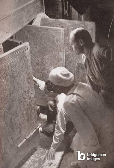 Image of Howard Carter and associates opening the doors of King Tutankhamun's burial shrine in the Valley of the Kings, Egypt; screen print from a photograph, 1923, Photo © GraphicaArtis / Bridgeman Images