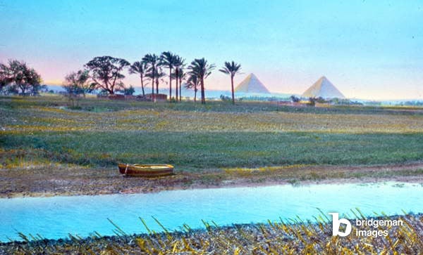 Colour photograph of the River Nile in Giza, Egypt. The pyramids can be seen in the distance. Dated 1910 / Universal History Archive/UIG / Bridgeman Images