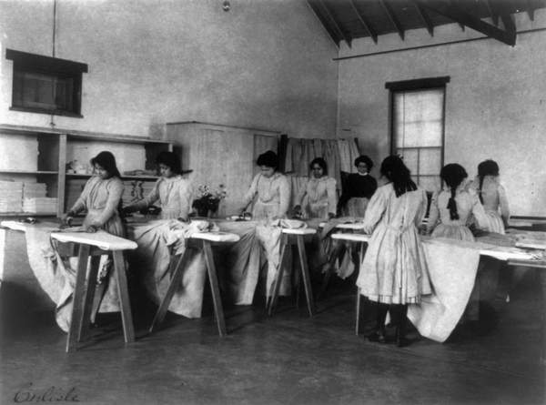 CARLISLE SCHOOL, c.1901 Ironing class at the Carlisle Indian School in Carlisle, Pennsylvania. Photograph by Frances Benjamin Johnston, c.1901. / Granger / Bridgeman Images