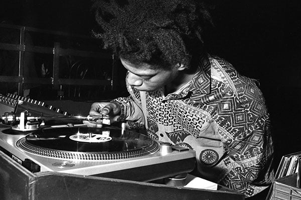 Jean-Michel Basquiat DJing at Area, New York, 1985 (b/w photo) / Photo © Ben Buchanan / Bridgeman Images 