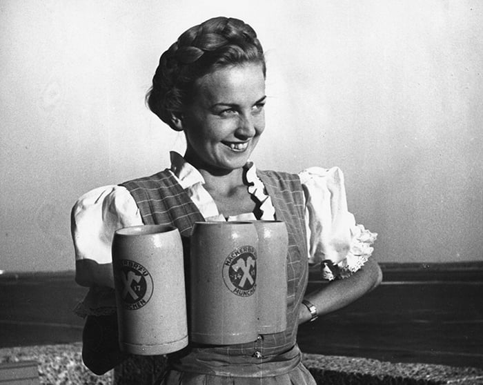 SZP1076322 Oktoberfest waitress in a dirndl with beer mugs of Hacker brewery, Munich, Germany, 1930s (b/w photo); © SZ Photo / Fotoarchiv Otfried Schmidt; PERMISSION REQUIRED FOR NON EDITORIAL USAGE; out of copyright PLEASE NOTE: Bridgeman Images works with the owner of this image to clear permission. If you wish to reproduce this image, please inform us so we can clear permission for you.