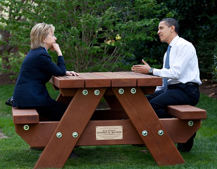 President Barack Obama and Secretary of State Hillary Rodham Clinton speak together sitting at a picnic table April 9, 2009, on the South Lawn of the White House