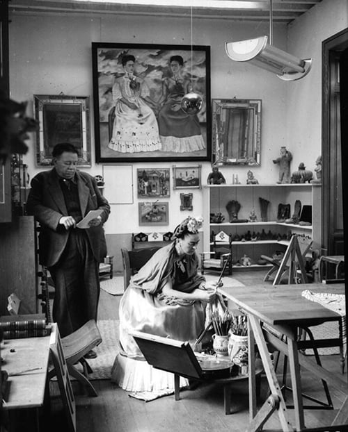 1699649 Mexican painters Frida Kahlo (1907-1954) and Diego Rivera (1886-1957) in their workshop in 1948 by ; (add.info.: La peintre mexicaine Frida Kahlo (1907-1954) avec son mari le peintre Diego Rivera (1886-1957) dans leur atelier dans la "maison bleue" a Coyoacan, Mexico en 1948 (on apercoit le tableau Les Deux Fridas) --- Mexican painters Frida Kahlo (1907-1954) and Diego Rivera (1886-1957) in their workshop in 1948); RESTRICTIONS MAY APPLY FOR COMMERCIAL USE - PLEASE CONTACT US; in copyright. PLEASE NOTE: This image is protected by the artist's copyright which needs to be cleared by you. If you require assistance in clearing permission we will be pleased to help you.