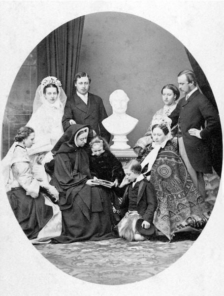  VICTORIA (1819-1901) & FAMILY Queen of Great Britain, 1837-1901. Victoria, in black mourning, with her children and a bust of "Dear Albert," c. 1863-65. / Photo © Granger 