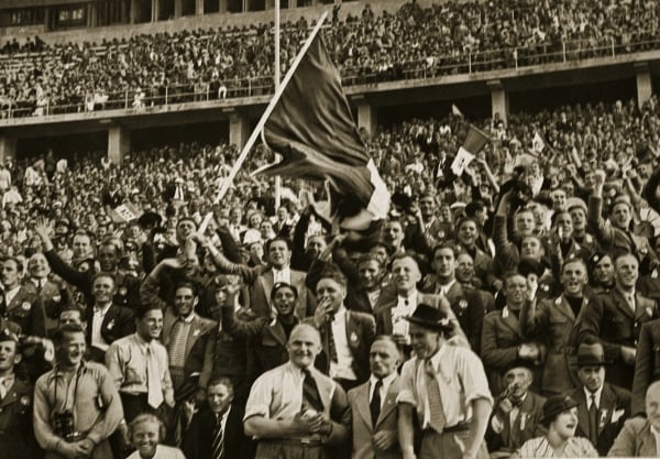 STC359519 The Italian fans in the Olympic stadium cheering on the winning team against Austria with many cheers and the waving of all sorts of flags, 1936 (b/w photo) by German Photographer, (20th century); Private Collection; (add.info.: from 'Olympia 1936: Die Olympischen Spiele 1936 in Berlin und Garmisch-Partenkirchen, Band 2', pub. by Cigaretten-Bilderdienst; Italy won the 1936 Olympic football tournament;); The Stapleton Collection; German, it is possible that some works by this artist may be protected by third party rights in some territories