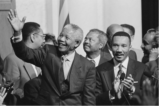 President of South Africa, Nelson Mandela with members of the Congressional Black Caucus. Oct. 4, 1994. Standing beside Mandela is Rep. Kweisi Mfume (born Frizzell Gerald Gray), Maryland Congressman / Photo © Everett Collection