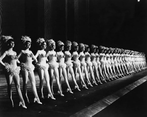 NEW YORK: ROCKETTES The Rockettes dance group performing at Radio City Music Hall in New York City. Photograph, mid 20th century. / Photo © Granger