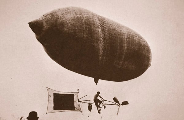 Sky cycle below a balloon, early 1900s (sepia photo)