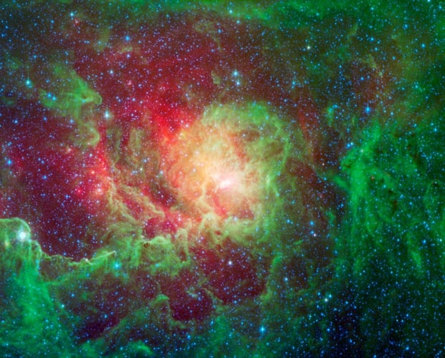 Swirling dust clouds and bright newborn stars dominate the view in this image of the Lagoon nebula from NASA's Spitzer Space Telescope. / Universal History Archive/UIG