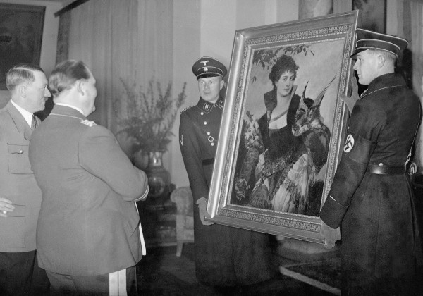Adolf Hitler presents Hermann Goering with a painting by Hans Makart, 'The Falconer' (1880), held by two men of the SS, Berlin, 1938, German Photographer, (20th century) / © SZ Photo / Scherl