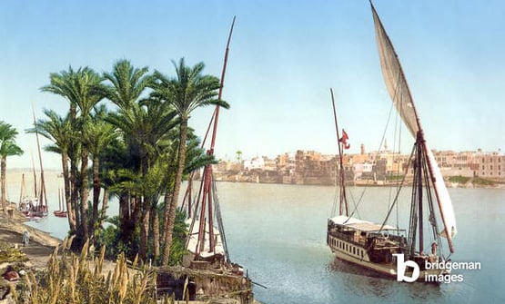  A sailboat on the Nile River with the city in the background, Cairo, Egypt. Photograph, late 19th century / Granger / Bridgeman Images