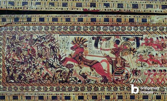 Tutankhamun (c.1370-1352 BC) on his chariot attacking Africans, detail from the side of a chest, New Kingdom, c.1340 BC (painted wood) / Bridgeman Images