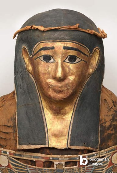 Mummy of Nesmin (detail of mummy mask with plant wreath), 200-30 BC / Bridgeman Images